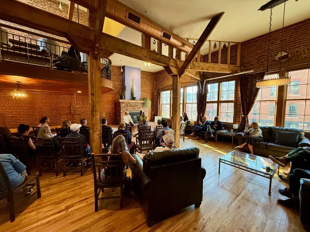 The full room at The Reserve, with the fireside chat across the floor