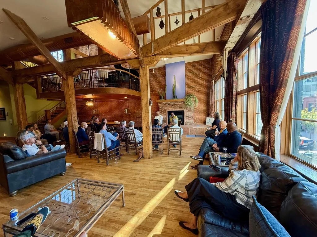 The fireplace, the hanging piano mezzanine, and the tall windows at The Reserve during the talk